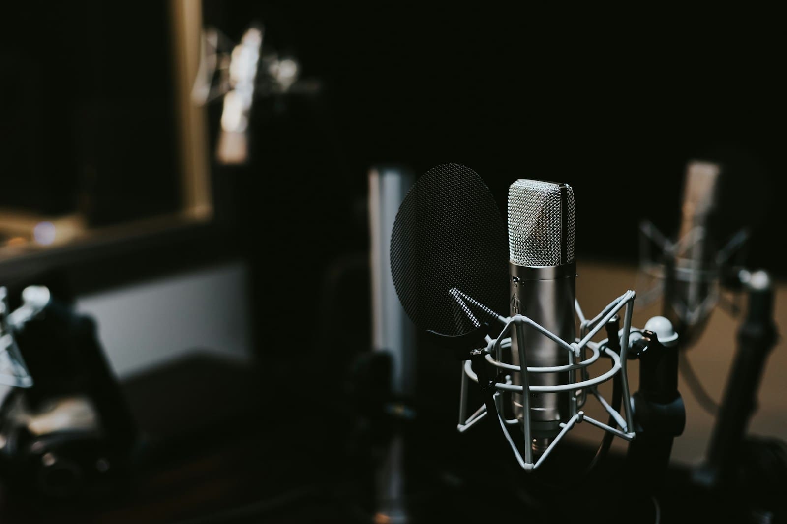 Photo by Jonathan Velasquez macro photography of silver and black studio microphone condenser